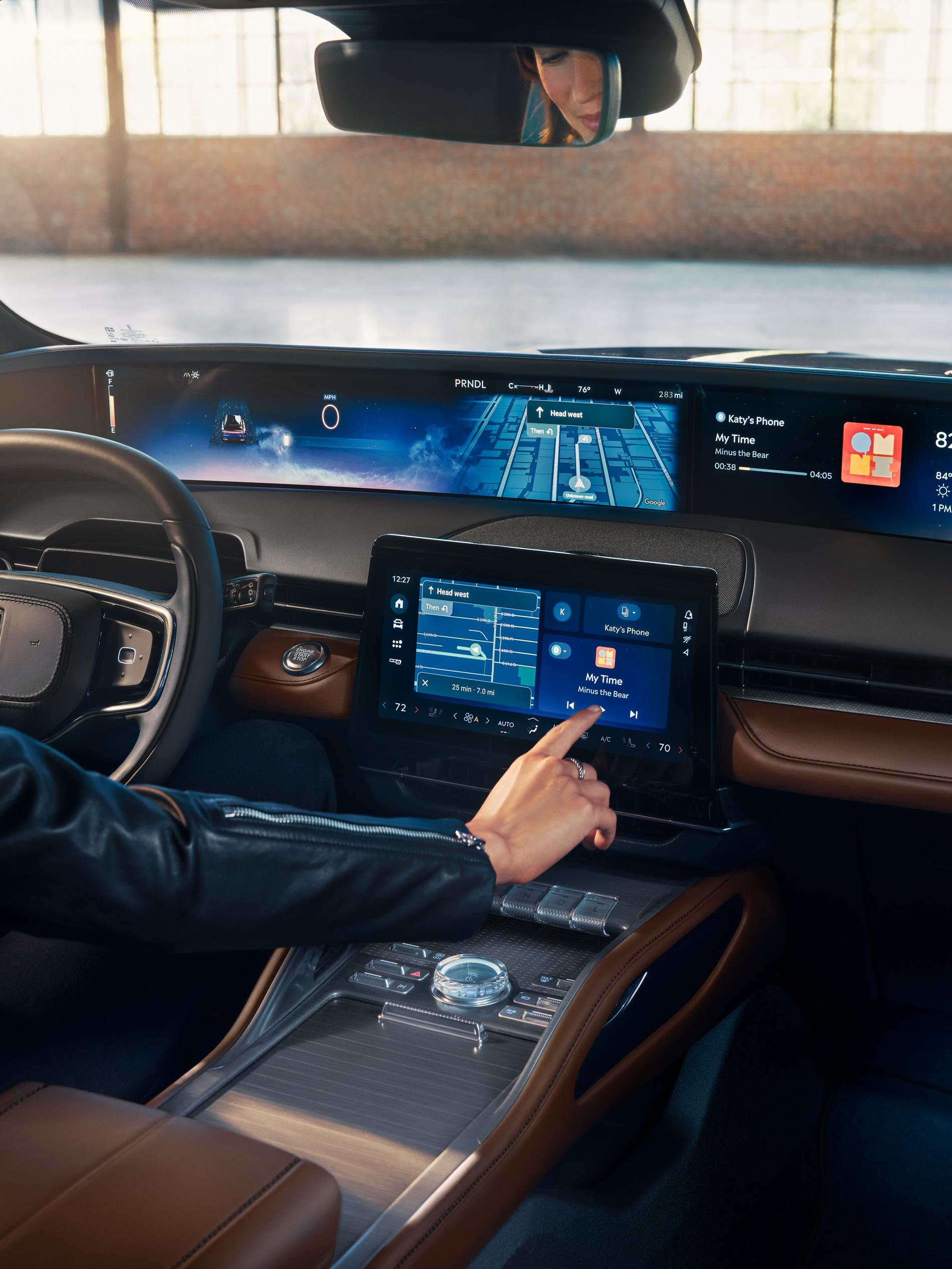 A person presses the center touch screen with their finger