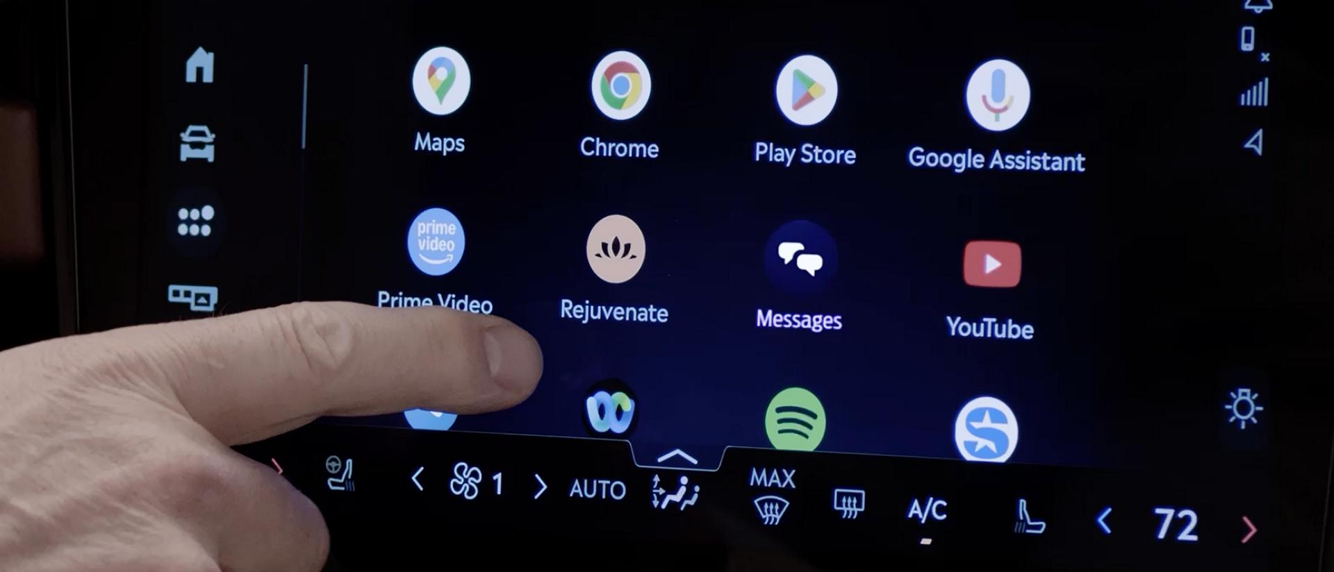A finger about to press the center touchscreen of a 2027 Lincoln Navigator® SUV