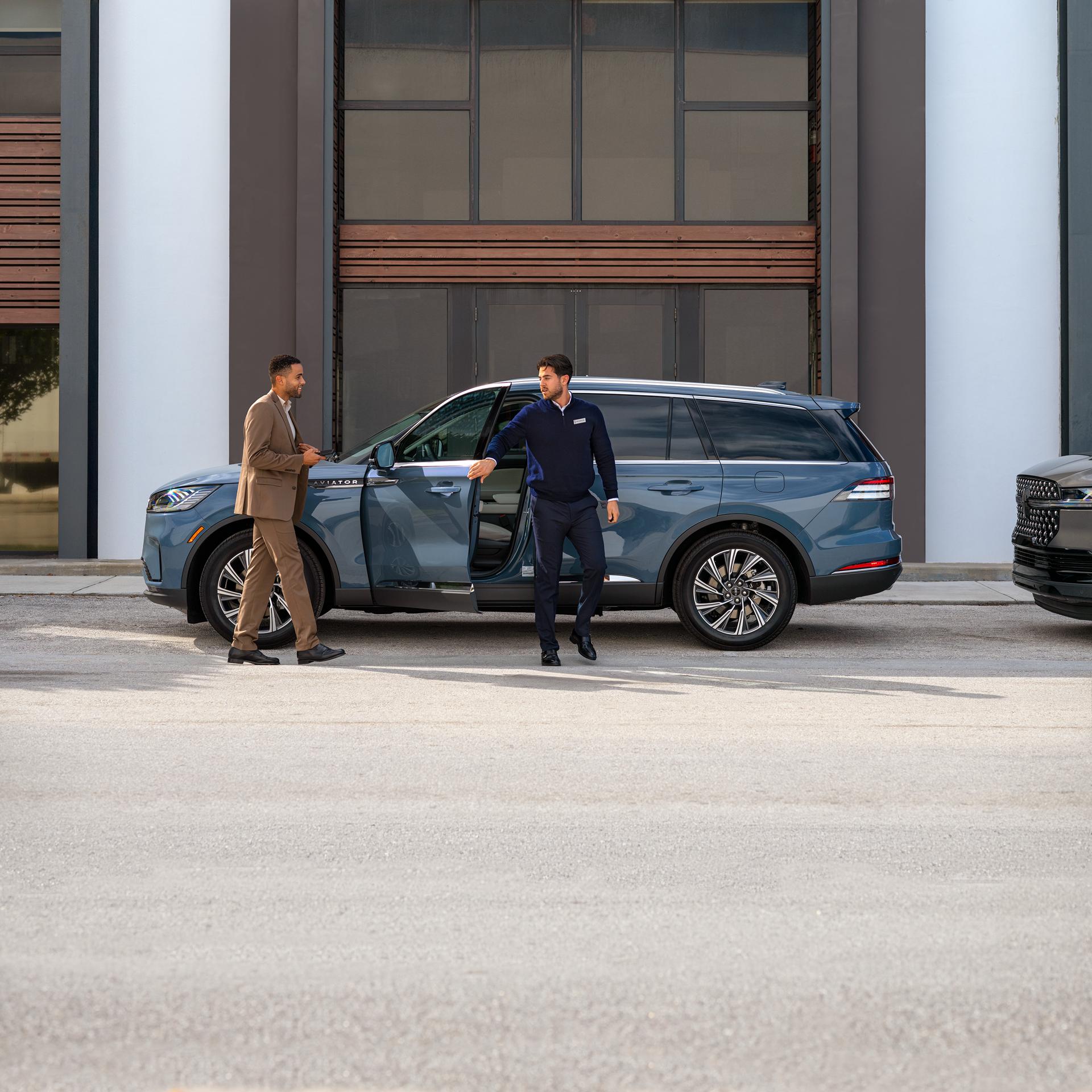 A Lincoln employee dropping off a Lincoln vehicle to its owner.