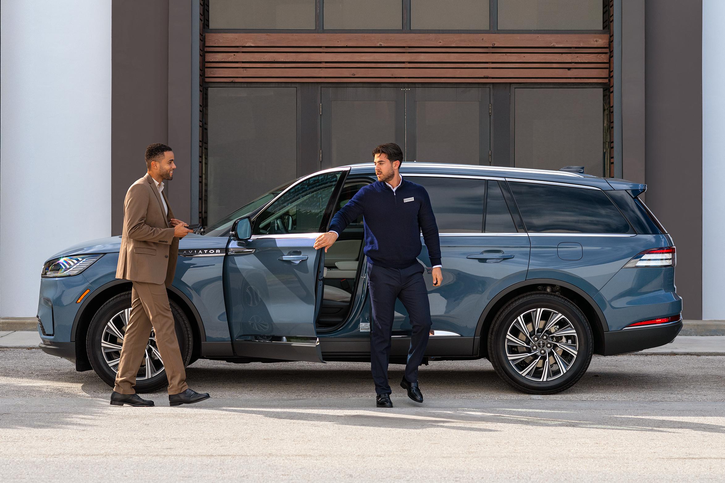 A Lincoln employee dropping off a Lincoln vehicle to its owner.