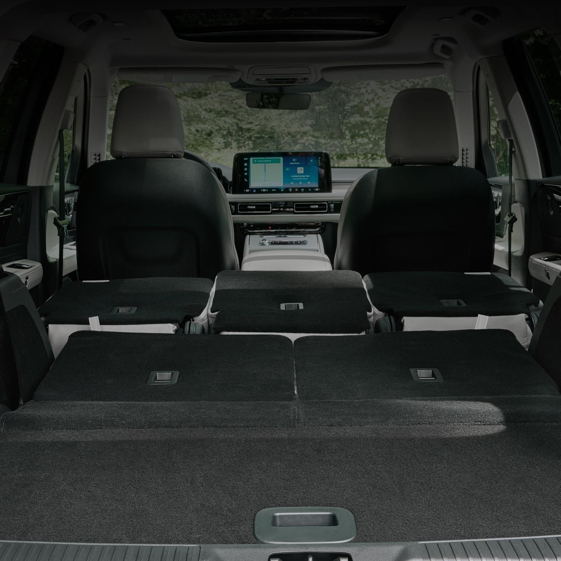 The full cabin of a 2027 Lincoln Aviator® SUV as seen from the open rear liftgate looking forward