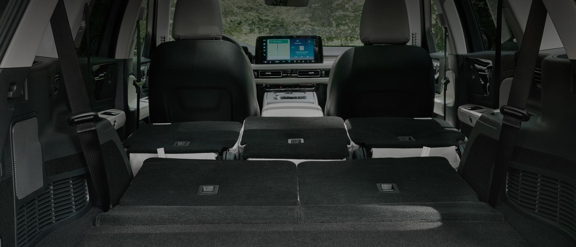 The full cabin of a 2027 Lincoln Aviator® SUV is shown through the opened rear lift gate
