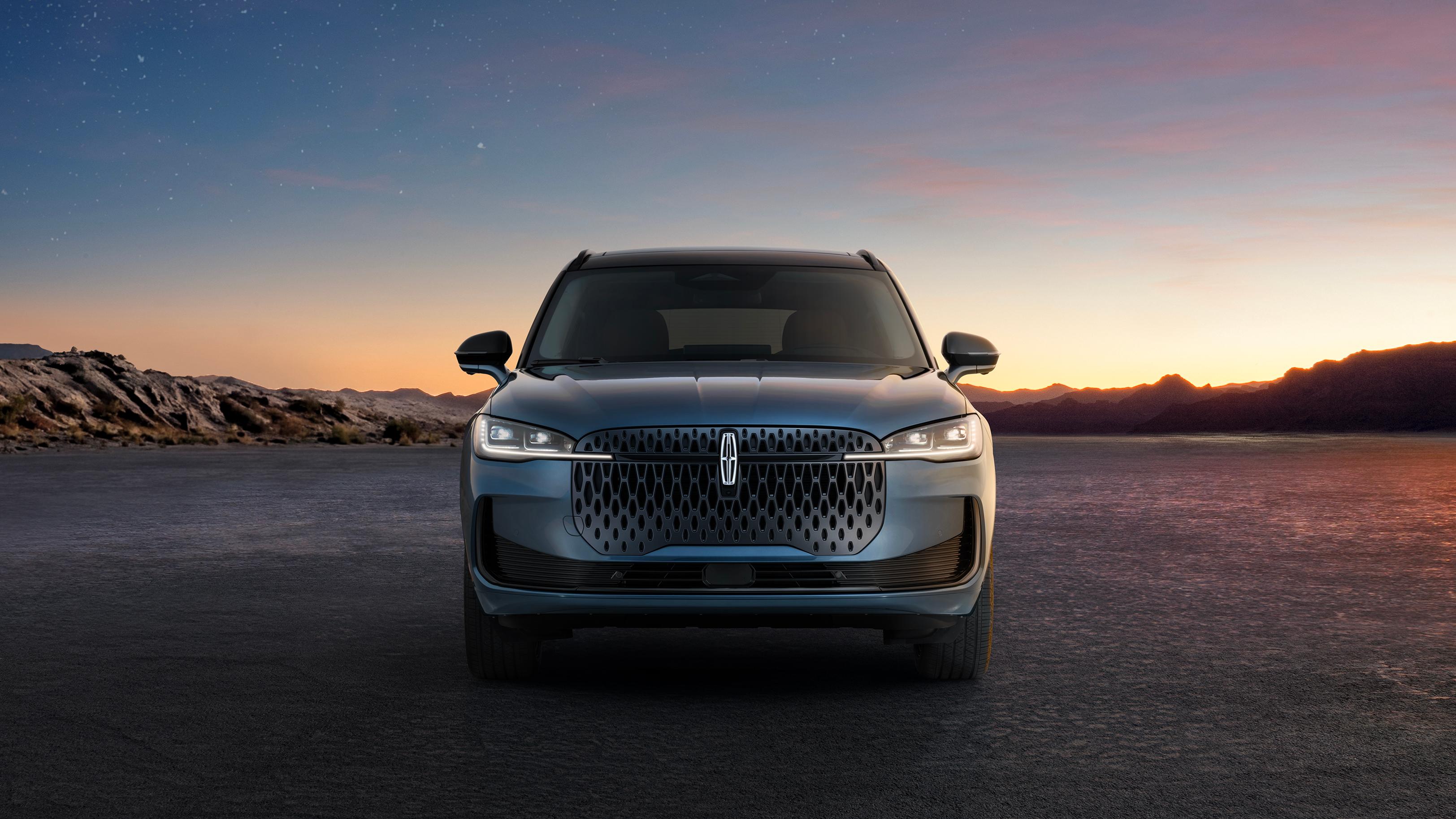 An illuminated Lincoln star emblem and light bar define the distinctive grille of the 2027 Lincoln Corsair® Hybrid
