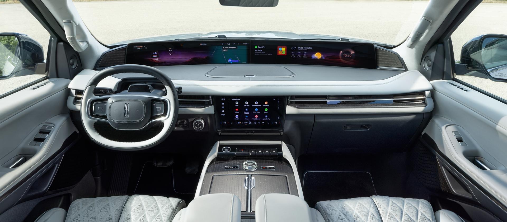 The panoramic display spans the width of a 2027 Lincoln Navigator Black Label™ SUV with the Atmospheric interior theme