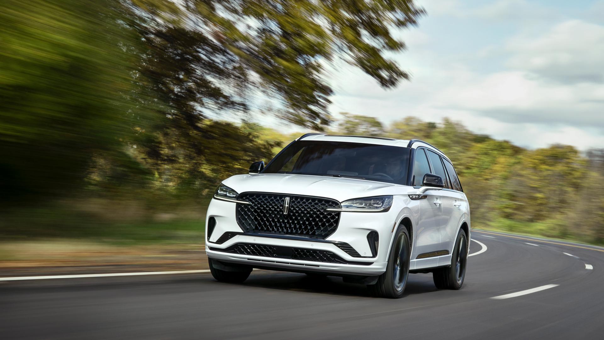 A 2026 Lincoln Aviator® SUV is being driven on a country road