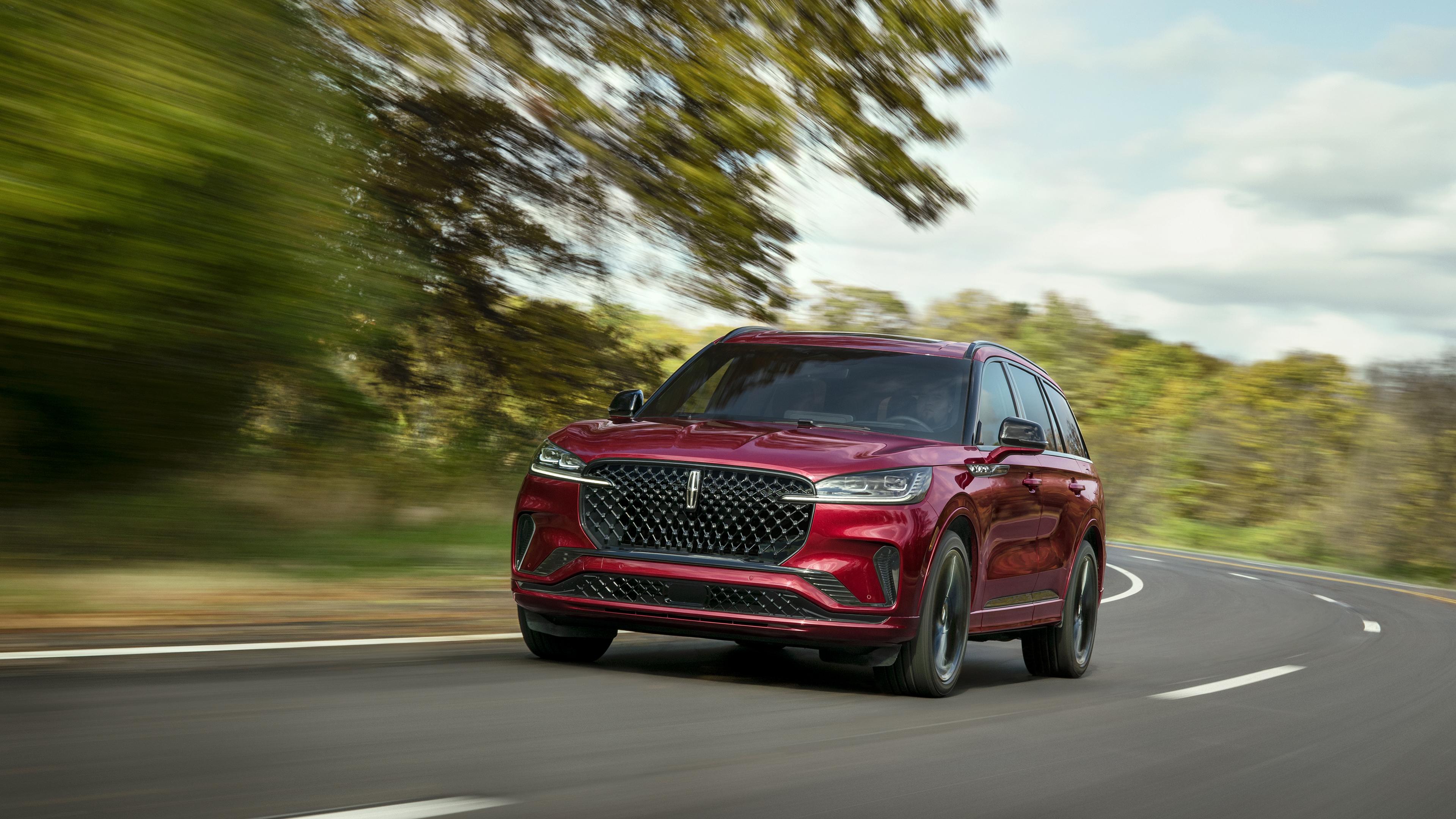 A 2027 Lincoln Aviator® SUV is being driven on a country road