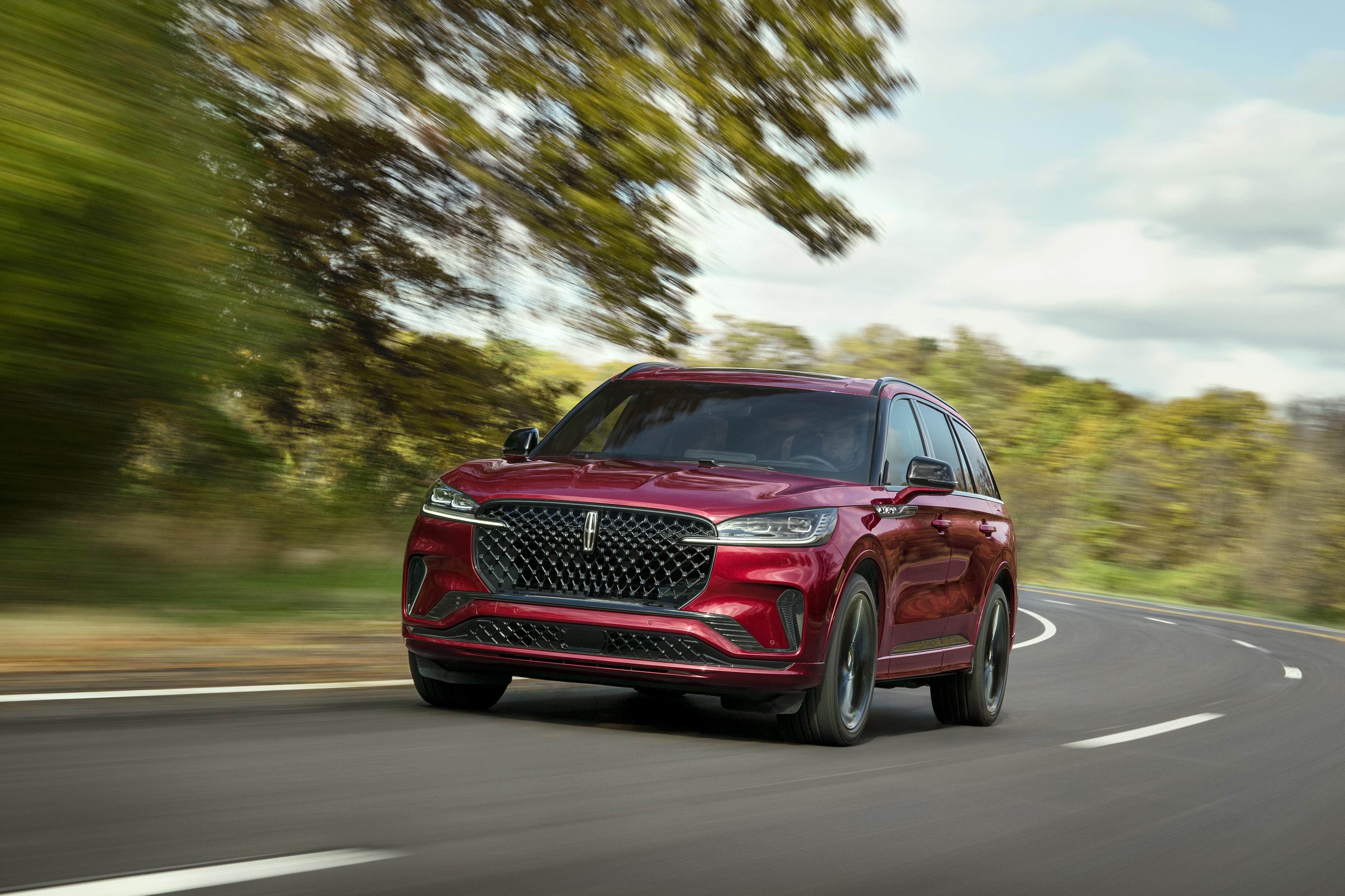 A 2027 Lincoln Aviator® SUV is being driven on a country road