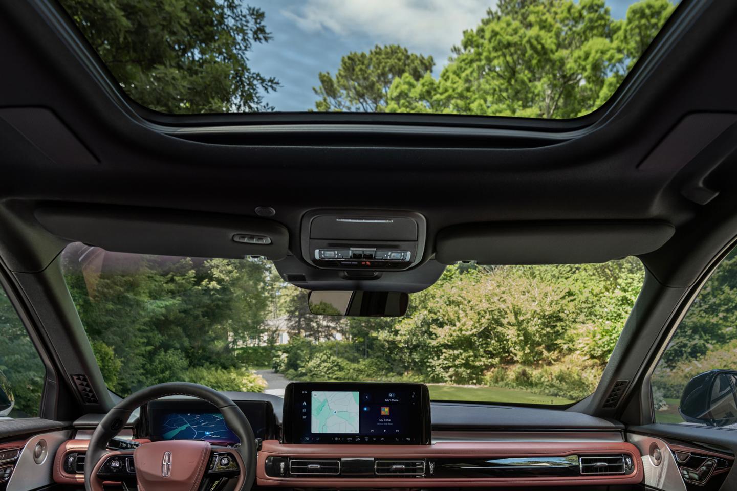 A smiling couple sitting in the 2025 Lincoln Aviator.