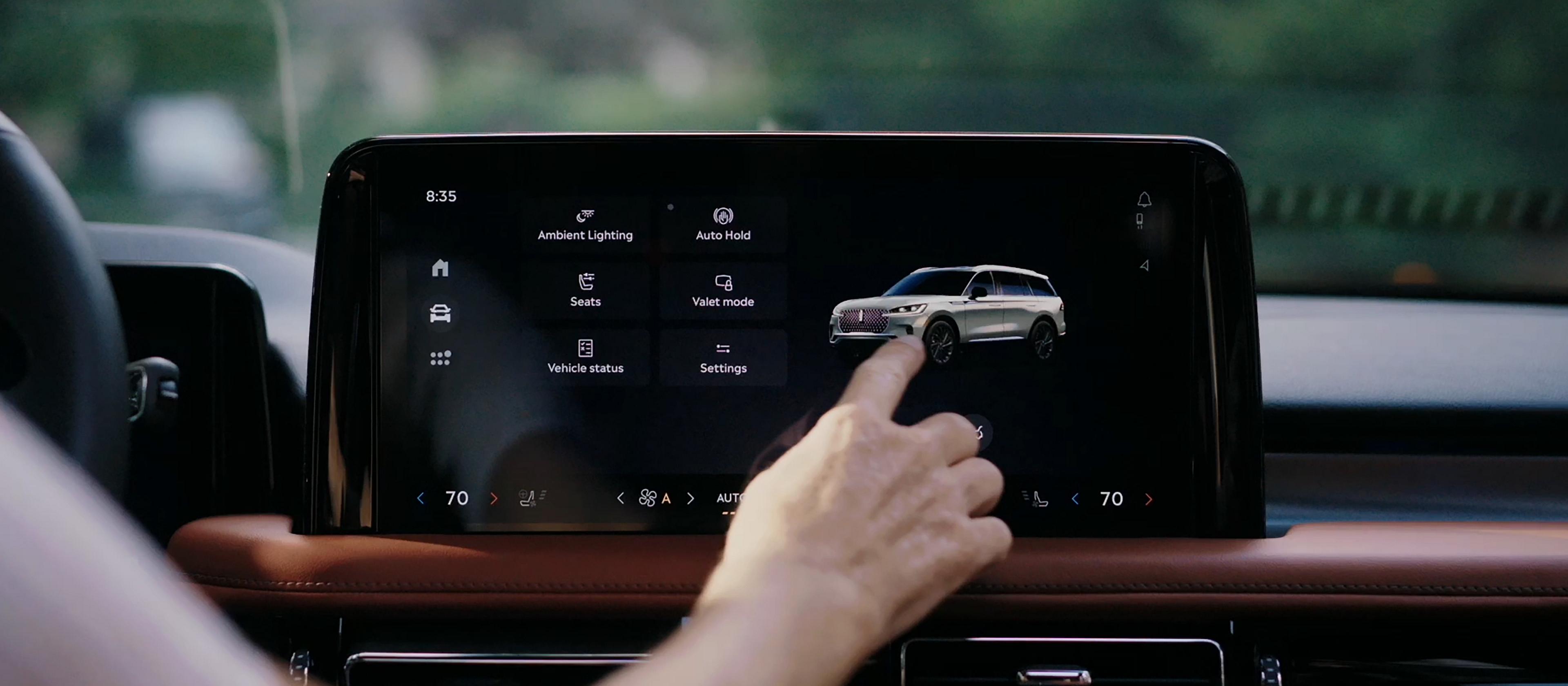 A person touches the center touchscreen to activate the power liftgate of a 2026 Lincoln Aviator® SUV