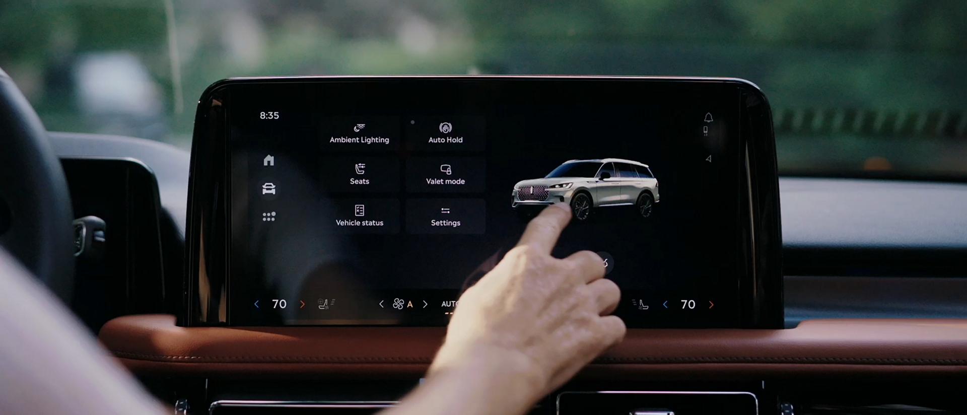 A person interacts with the center touchscreen of a  2026 Lincoln Aviator® SUV