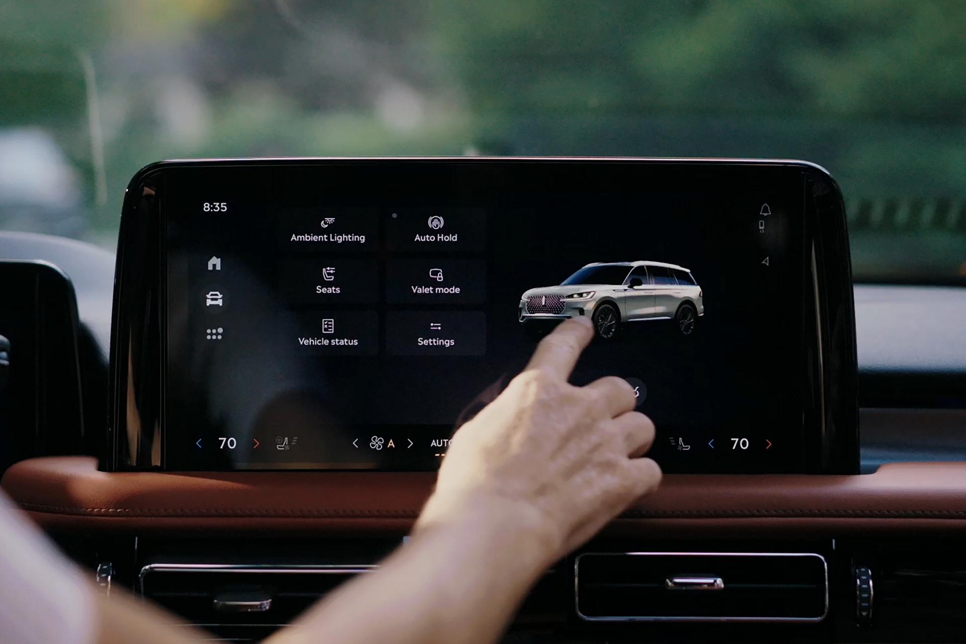 A person interacts with the center touchscreen of a  2026 Lincoln Aviator® SUV