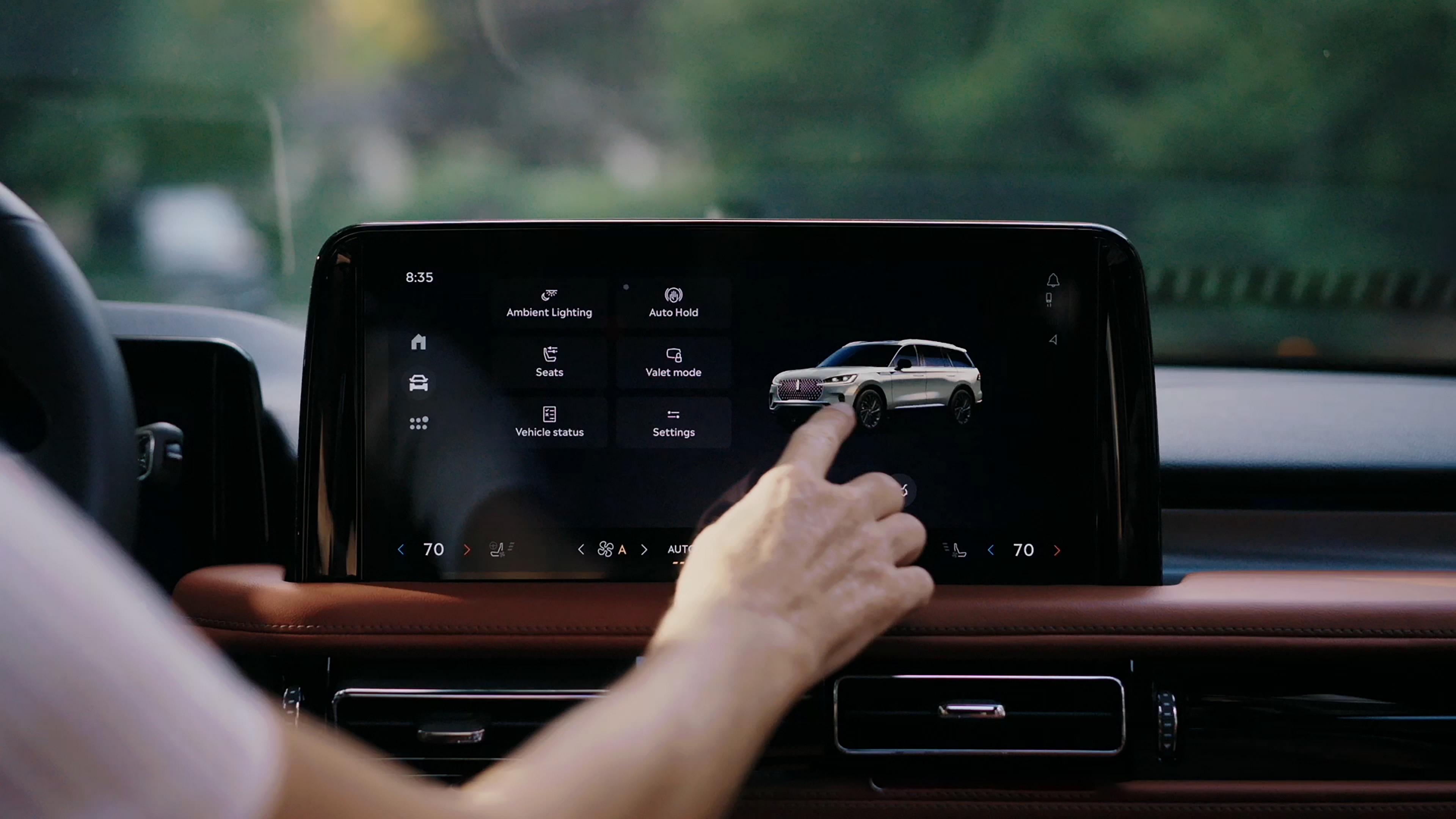A person touches the center touchscreen to activate the power liftgate of a 2026 Lincoln Aviator® SUV