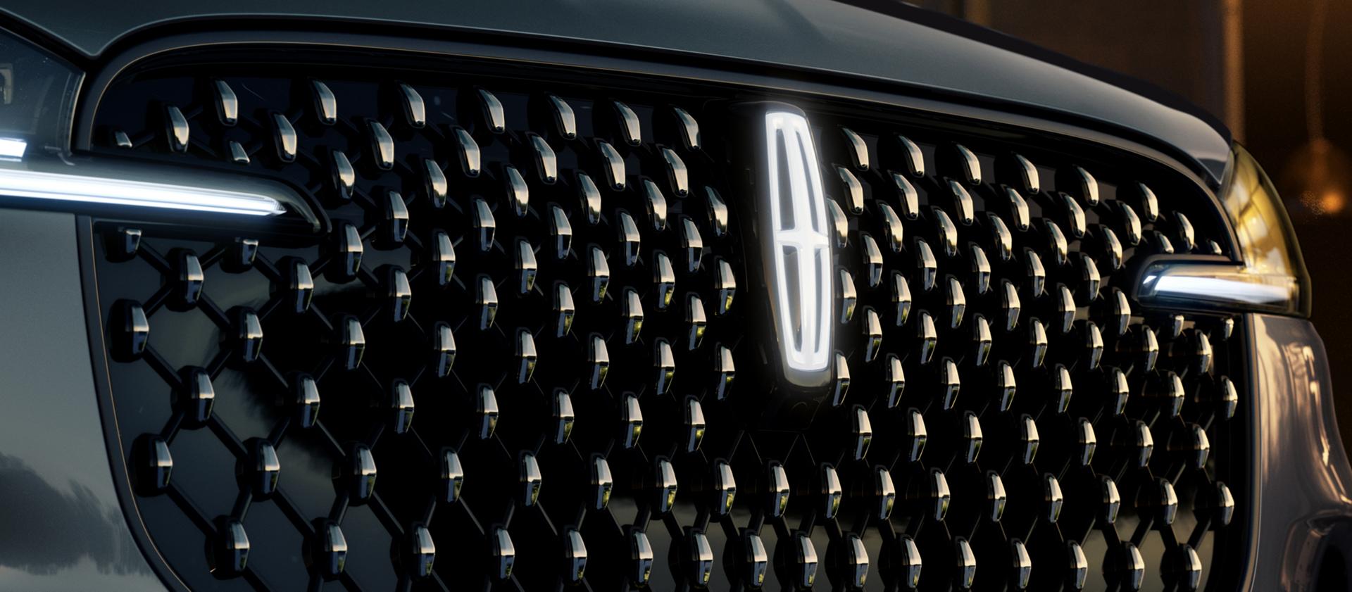 The grille of 2025 Lincoln Black Label Aviator® SUV with glowing Lincoln Star logo in the center