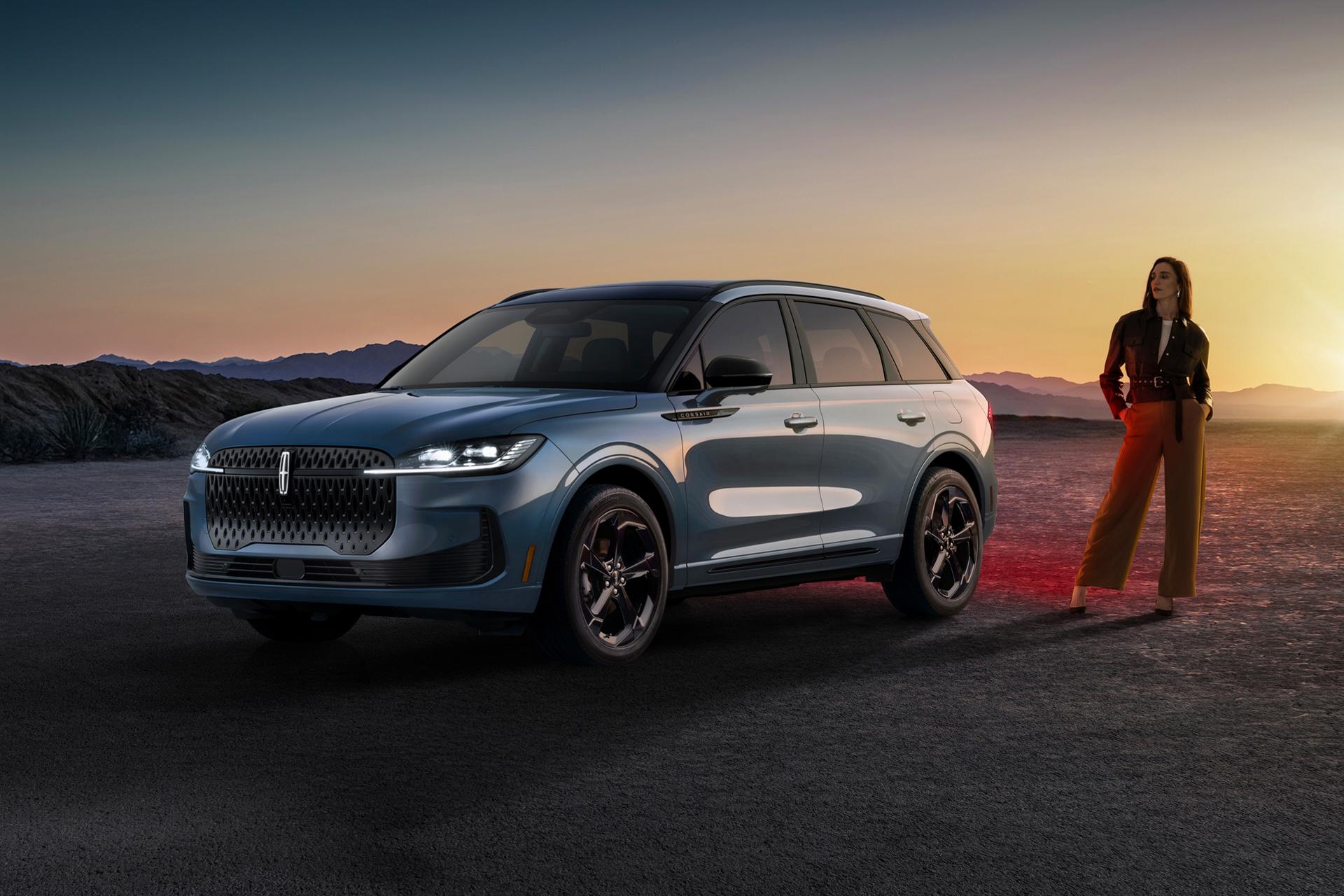 Una mujer vestida con estilo parada junto a una Lincoln Corsair® Hybrid 2027 estacionada en un espectacular paisaje desértico