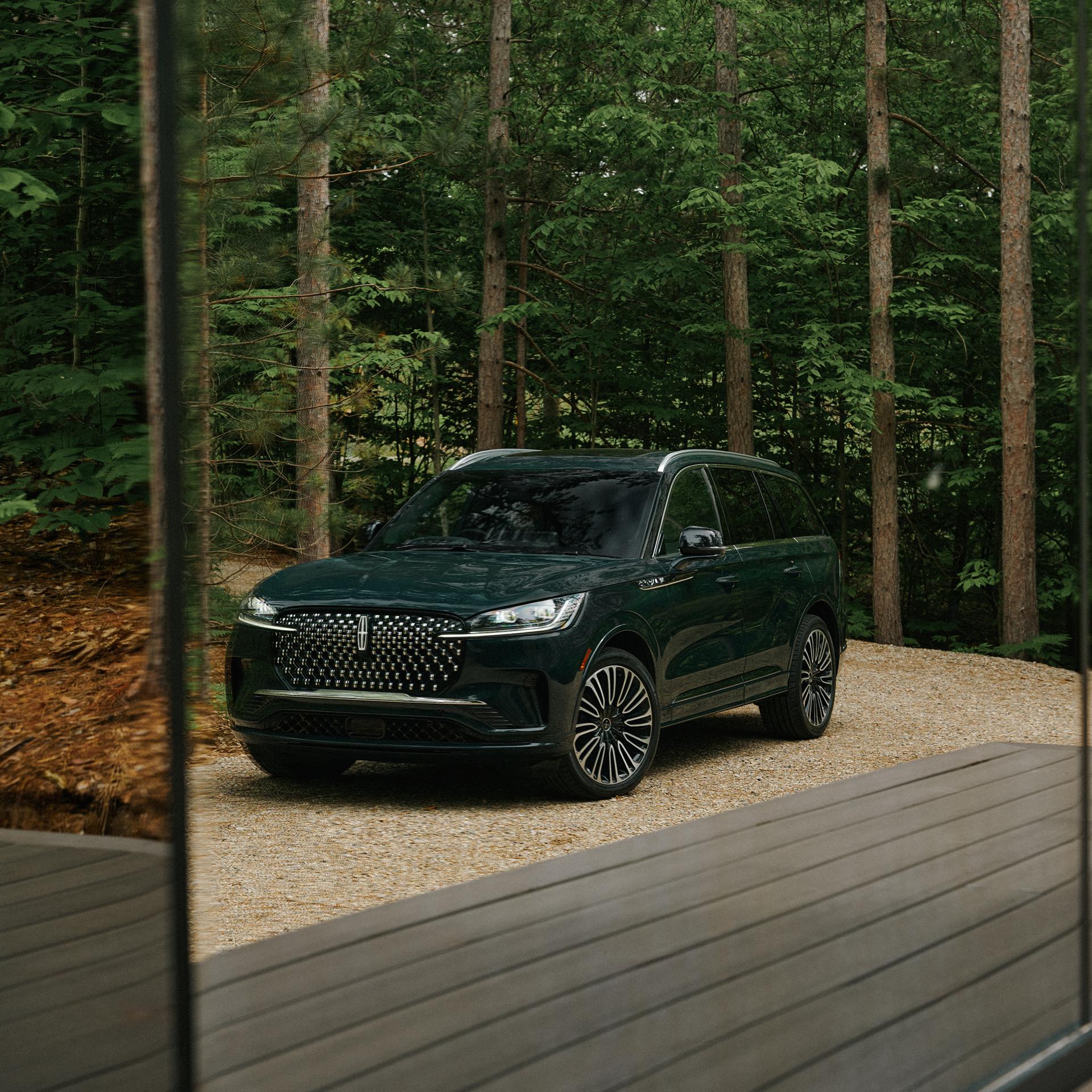 A 2027 Lincoln Aviator® Black Label™ SUV parked next to a high end glamping site