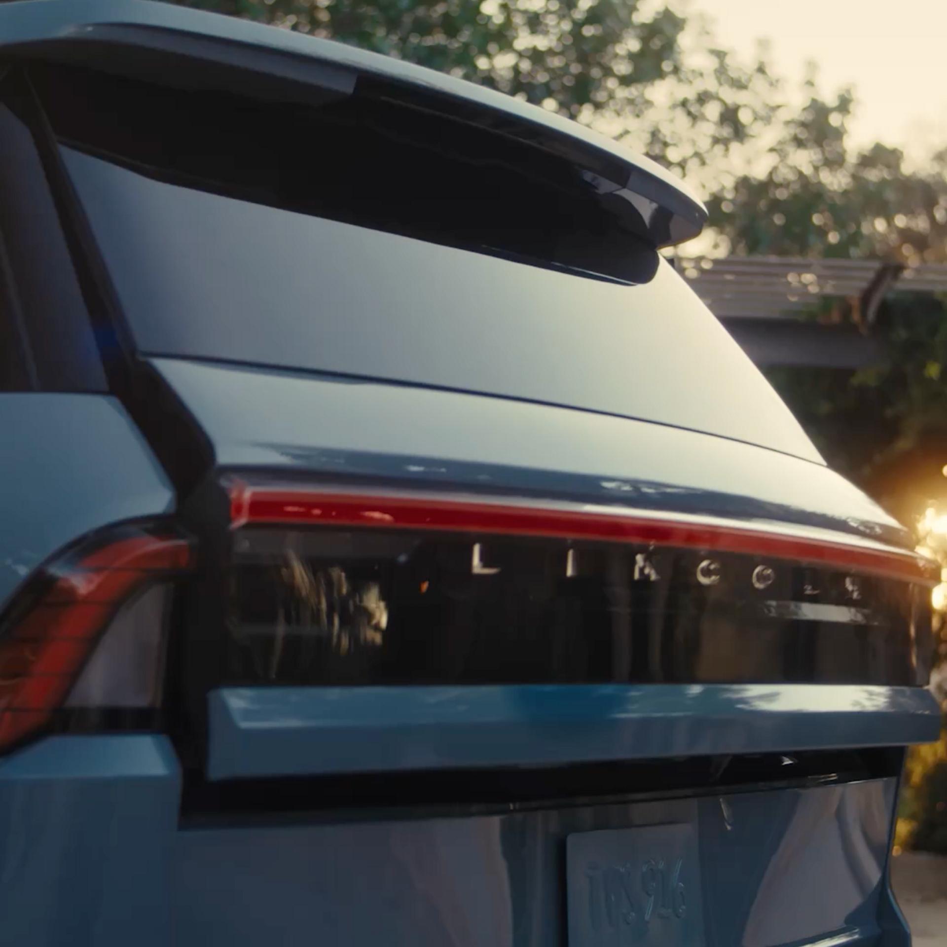 The back of a 2027 Lincoln Navigator® SUV opens the Lincoln Split Gate, showcasing the spacious cargo area