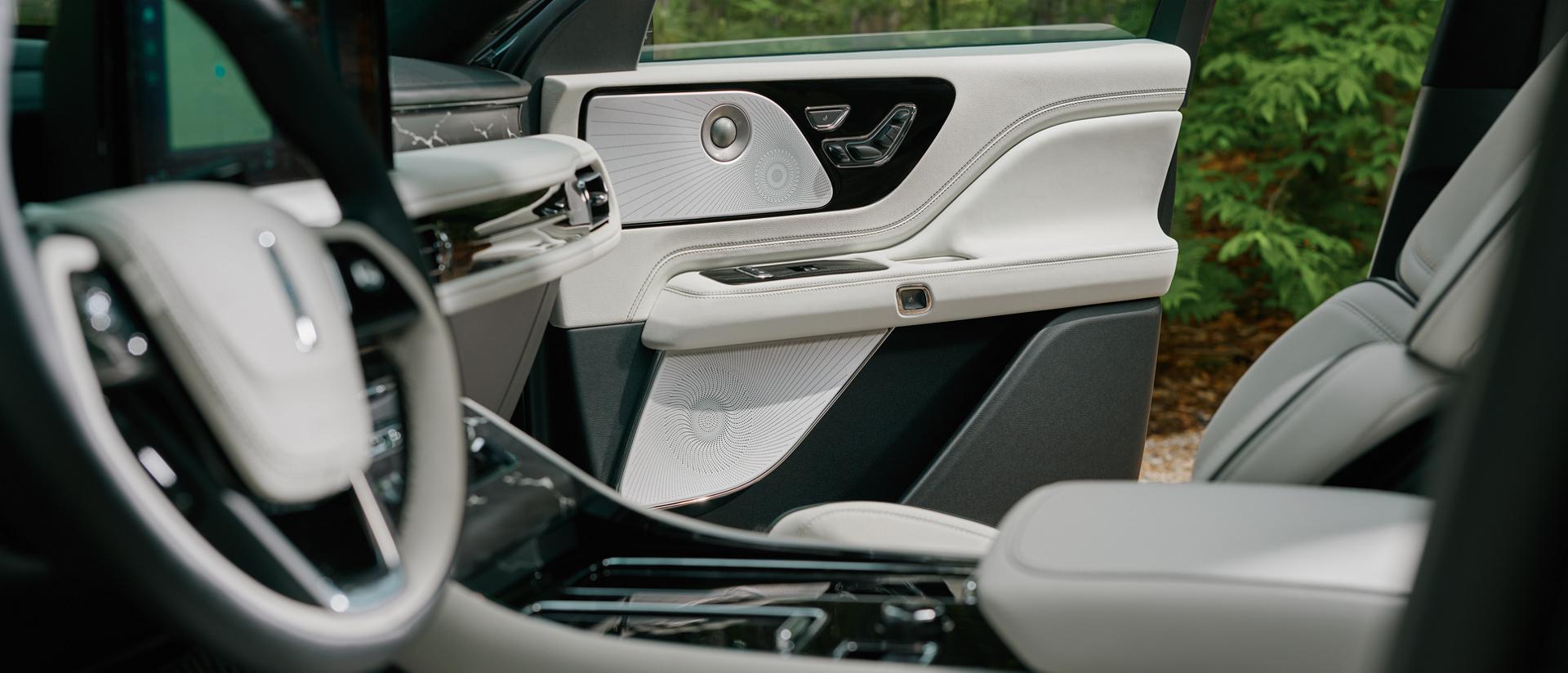 A grouping of audio system speakers in the front passenger door of a 2027 Lincoln Aviator® SUV