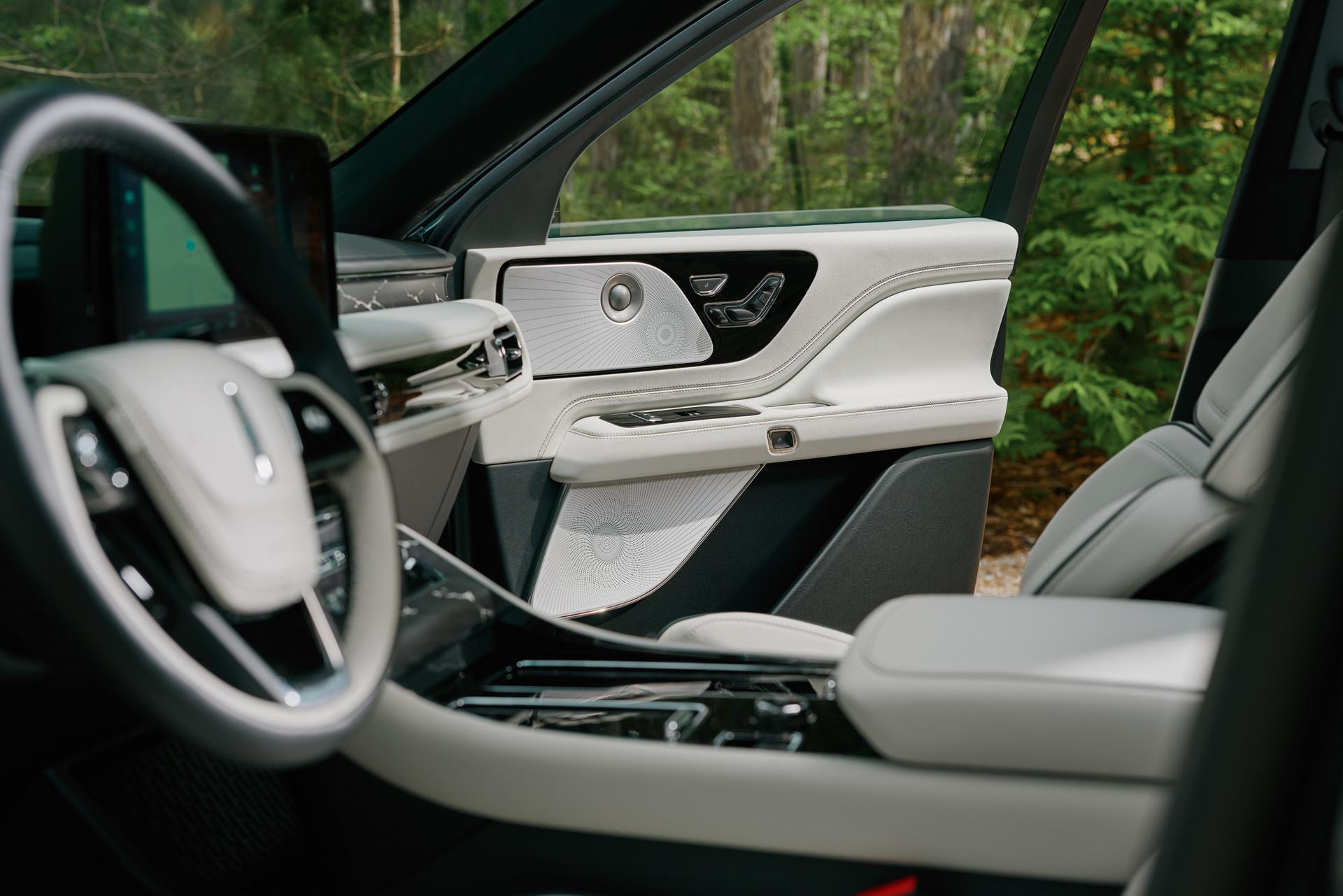 An audio system speaker is located in the front passenger door of a 2027 Lincoln Aviator® SUV