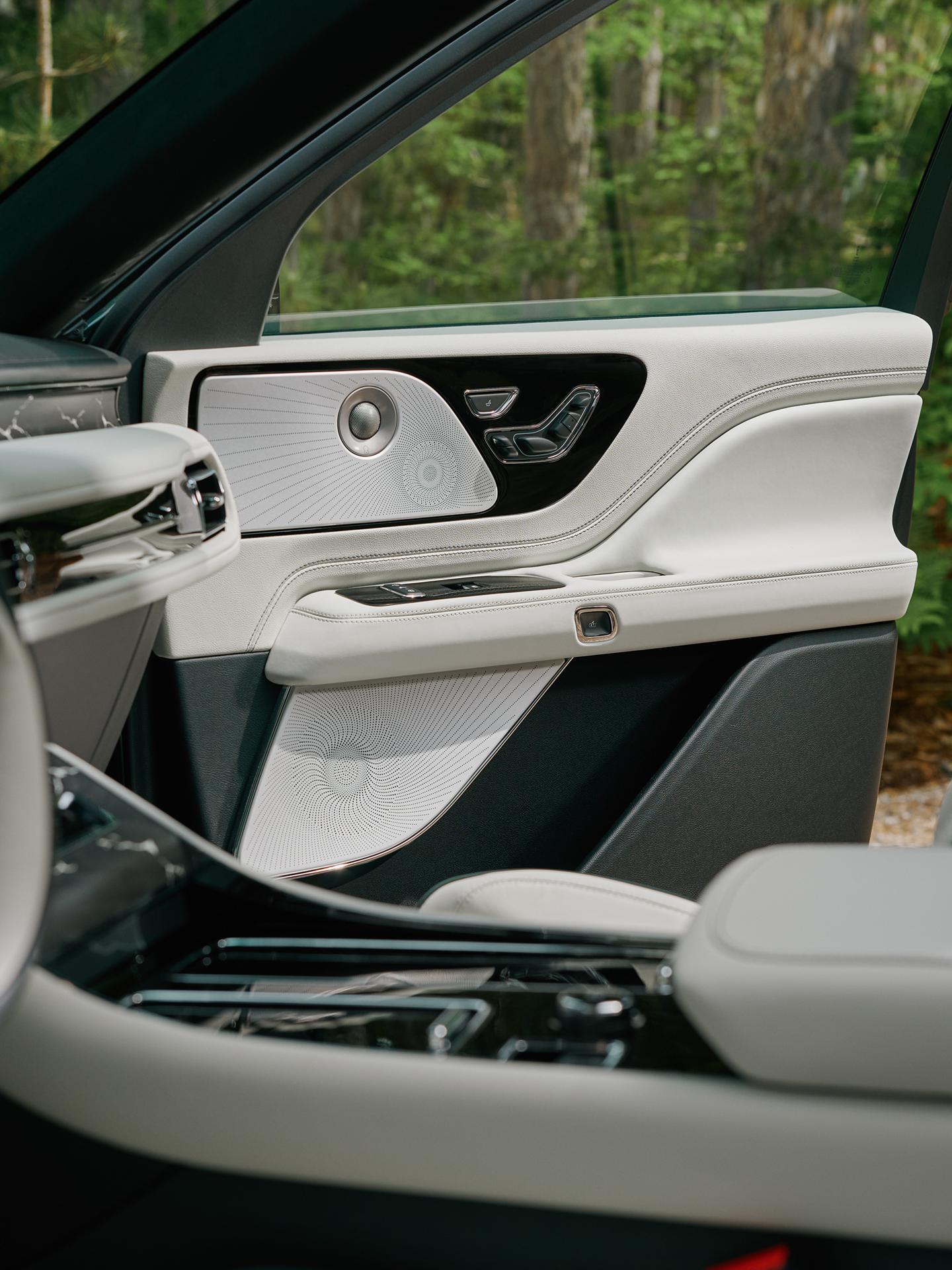 A grouping of audio system speakers in the front passenger door of a 2027 Lincoln Aviator® SUV