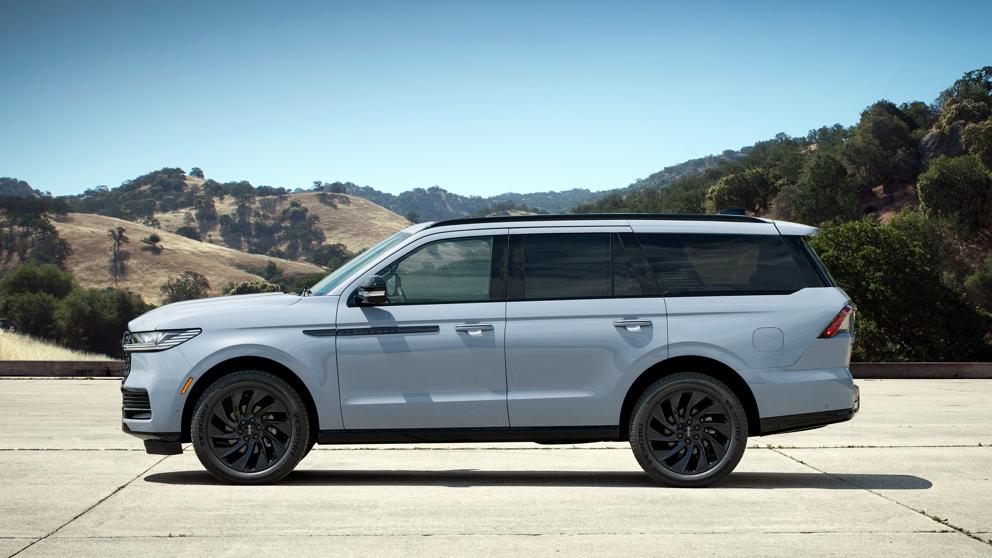 A 2027 Lincoln Navigator® SUV with the available Atmospheric Black Label™ theme is parked in front of a modern home