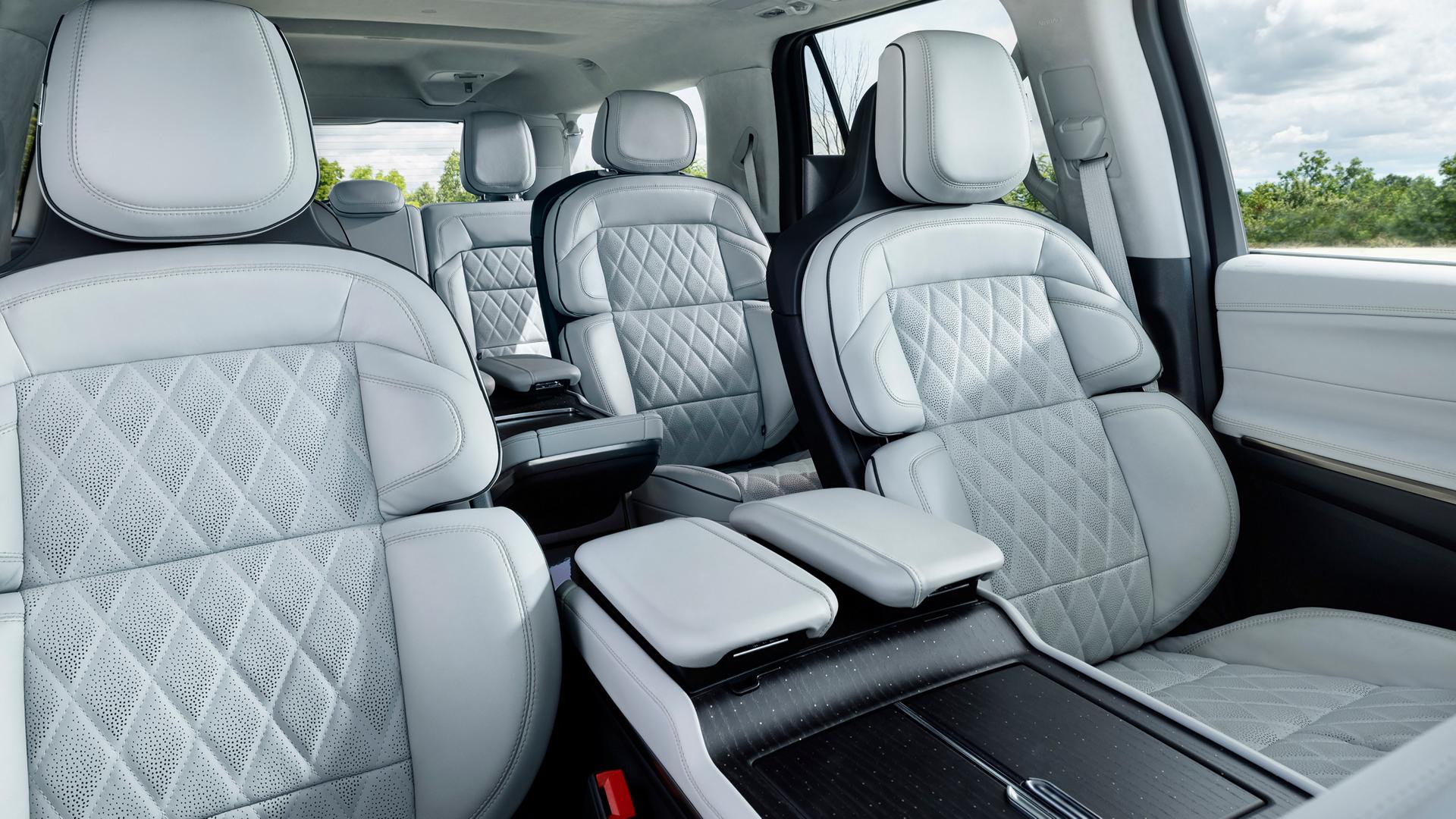 A woman drives a 2026 Lincoln Navigator Black Label while using the massage feature of the Perfect Position Seats