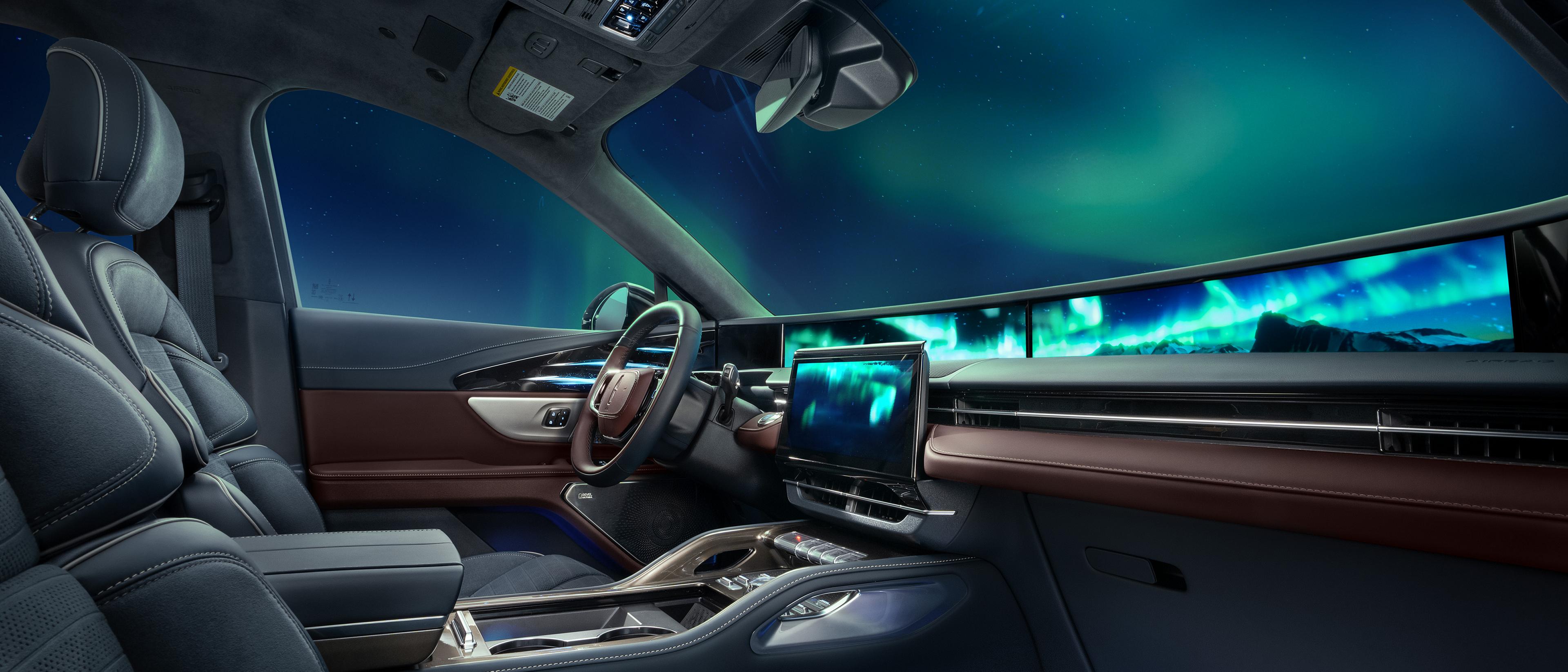The northern lights seen through the windshield of a 2026 Lincoln Black Label™ Nautilus® SUV with the Aurora interior theme