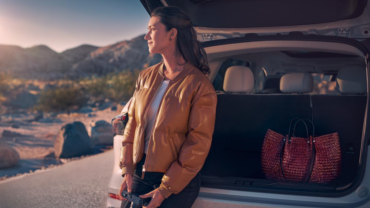 A woman sits in the rear cargo area of a 2026 Lincoln Nautilus® SUV