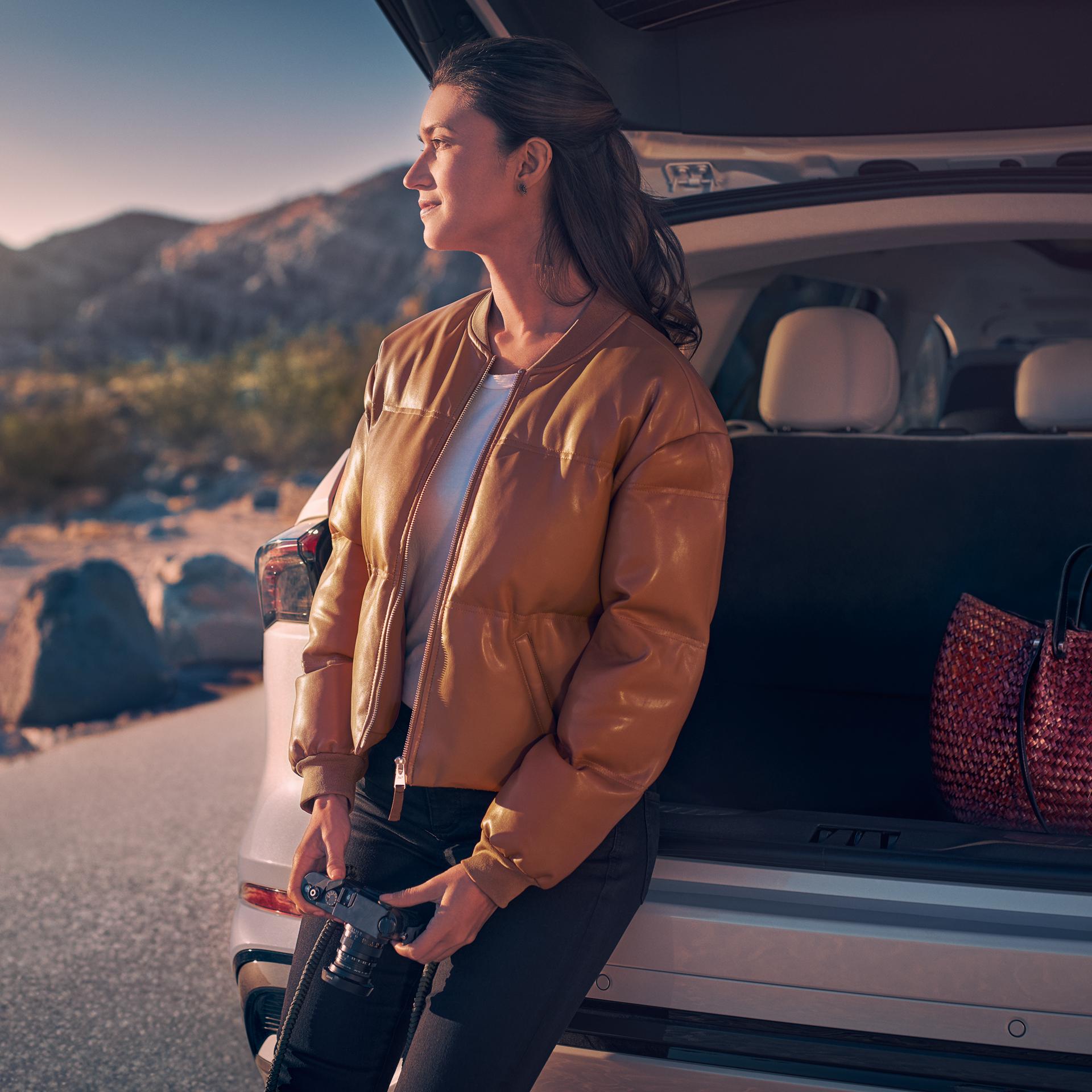 A woman sits in the rear cargo area of a 2026 Lincoln Nautilus® SUV