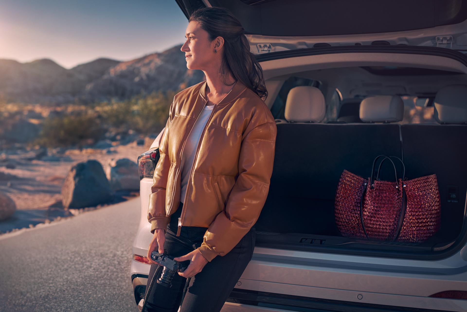 A woman sits in the rear cargo area of a 2026 Lincoln Nautilus® SUV