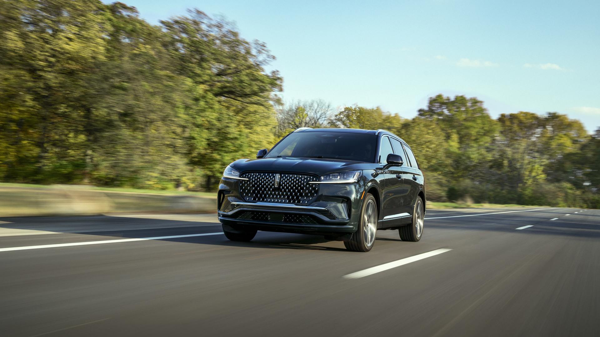 A 2027 Lincoln Aviator® SUV is being driven on a country road