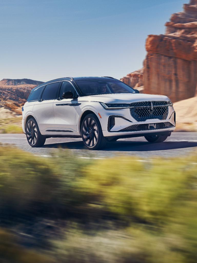 The Lincoln Nautilus is seen driving down the road.