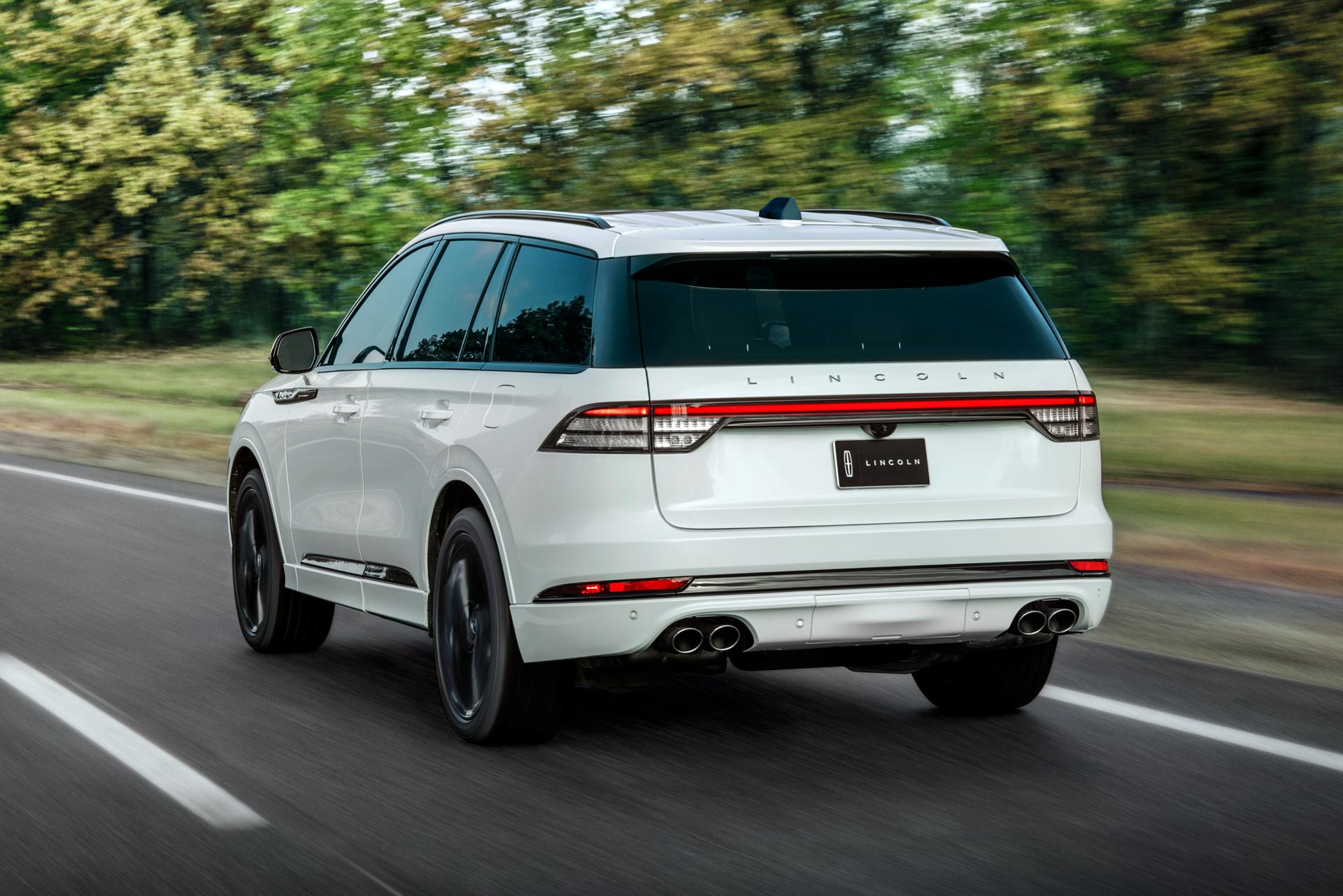 The 2025 Lincoln Aviator driving down a road.