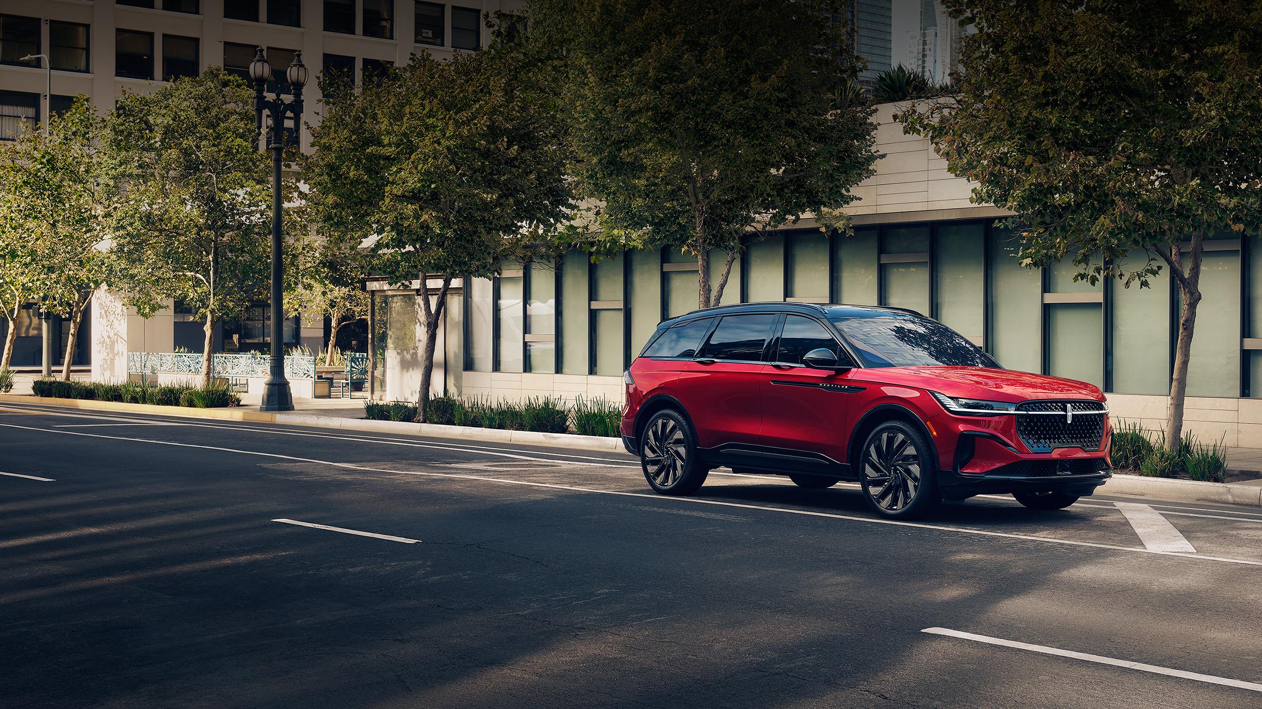 A 2025 Lincoln Nautilus® SUV parallel parked on an urban street