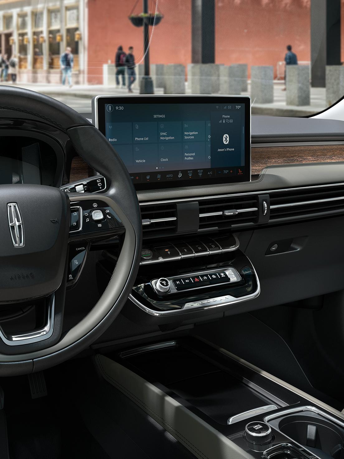Lincoln SYNC 4 center display showing navigation with a city street view in the windshield.
