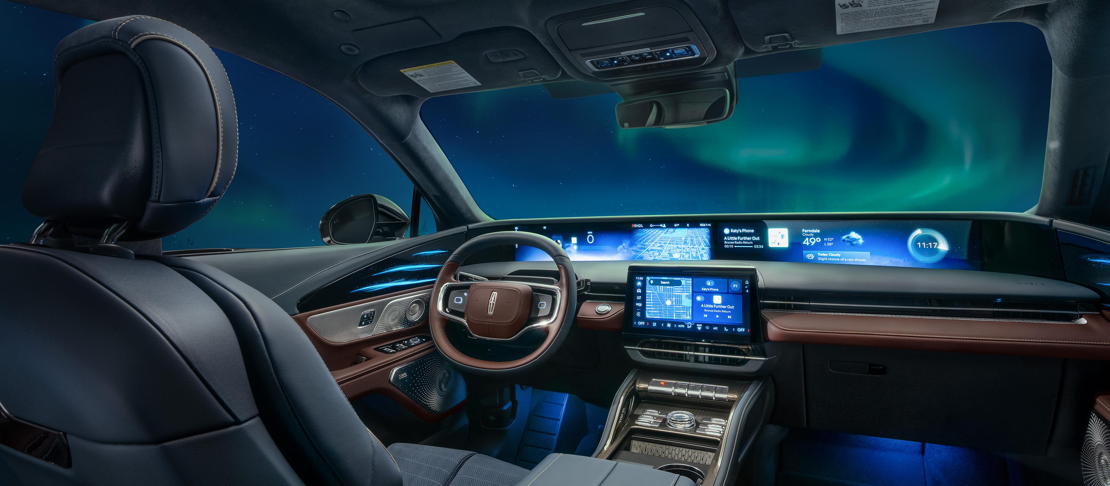 The Northern Lights are seen through the windshield of a 2026 Lincoln Black Label™ Nautilus® SUV with the Aurora interior theme
