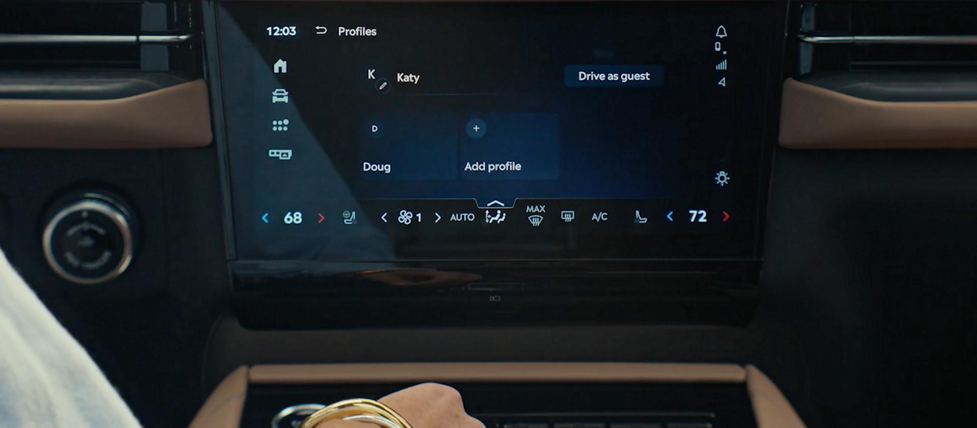 A woman in a 2026 Black Label Navigator is about to change the profile settings from her own to her husband's