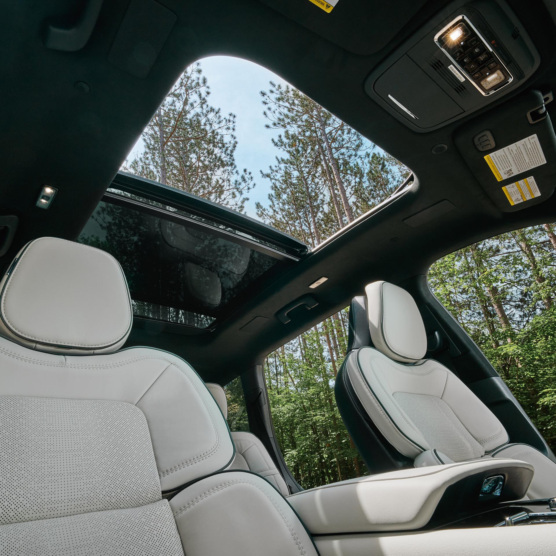 The available panoramic Vista Roof® is shown open from inside a 2027 Lincoln Aviator® SUV