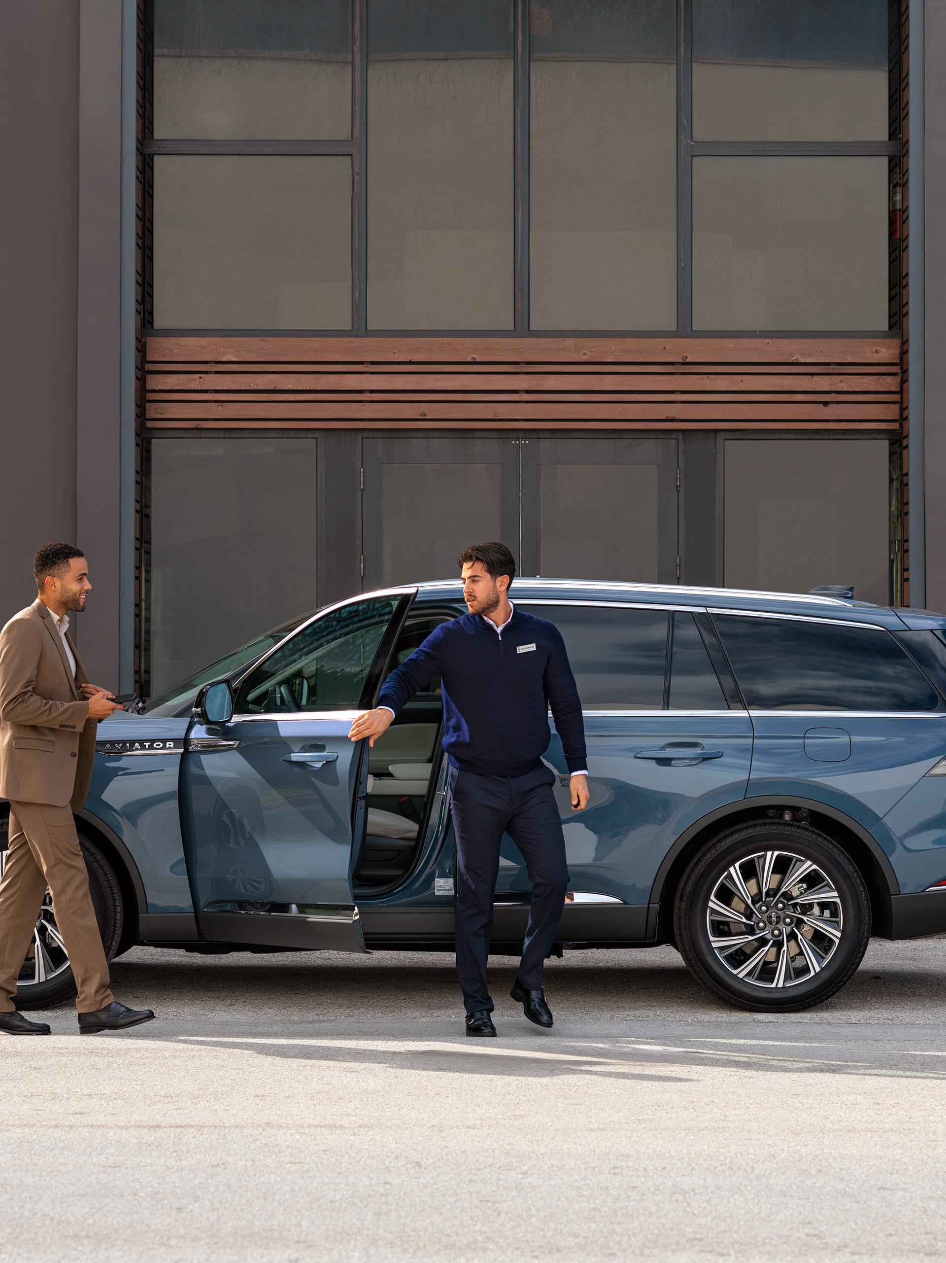 A Lincoln customer receives their keys back from a service advisor