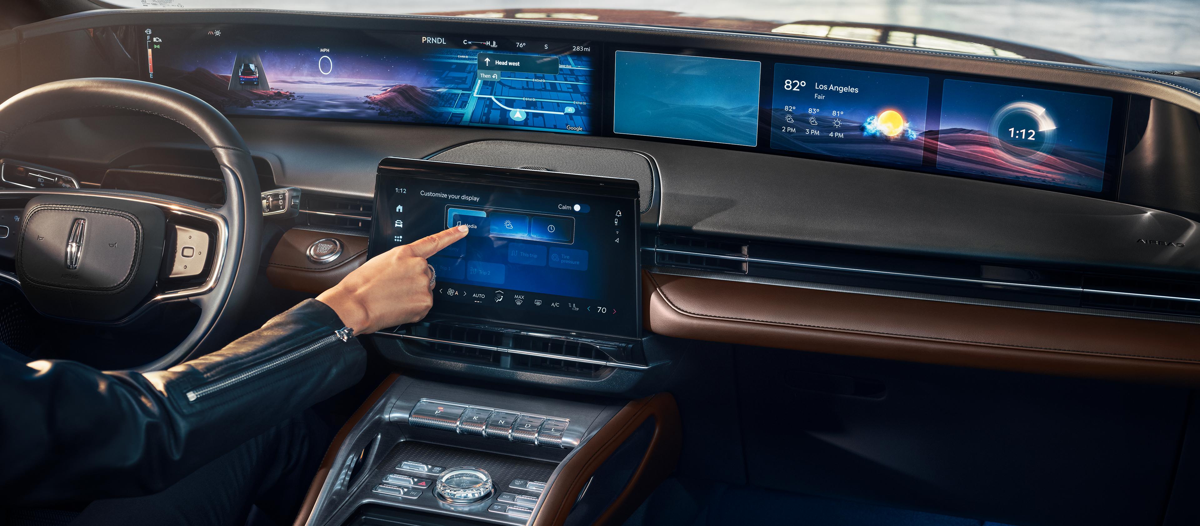 A person touches the center touchscreen of a 2026 Lincoln Nautilus® SUV