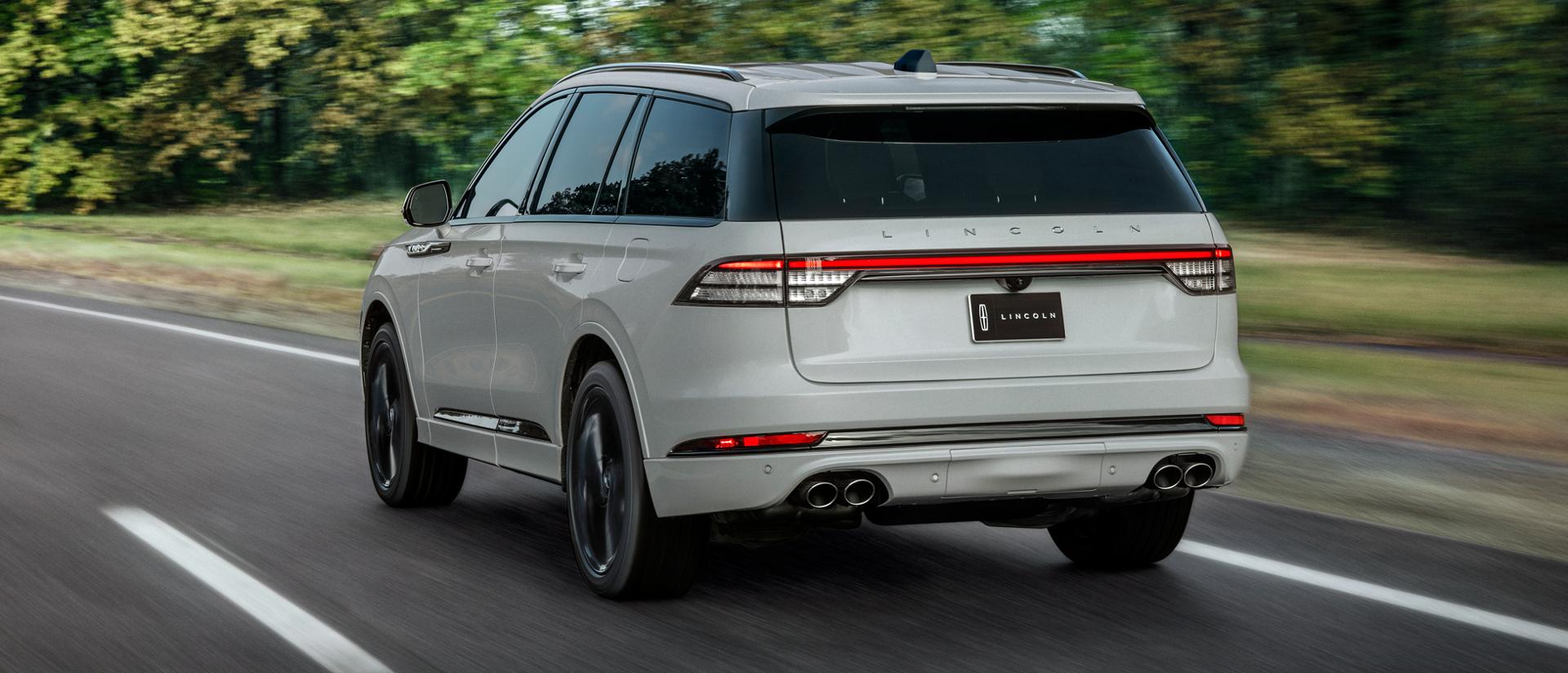 A 2027 Lincoln Aviator® SUV is being driven on a country road