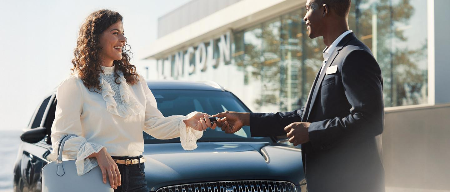 A Lincoln customer receives their keys back from a service advisor