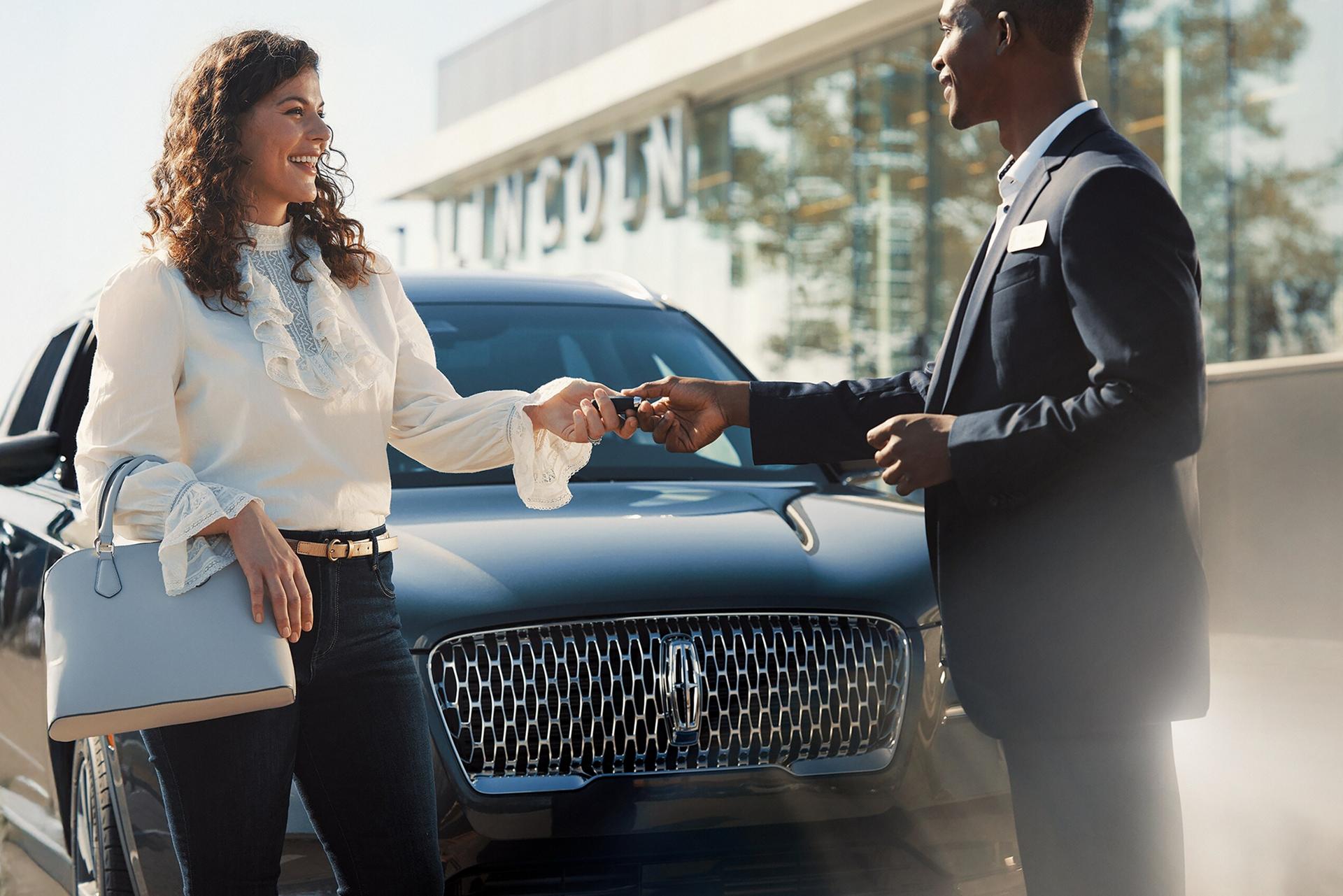 A Lincoln customer receives their keys back from a service advisor