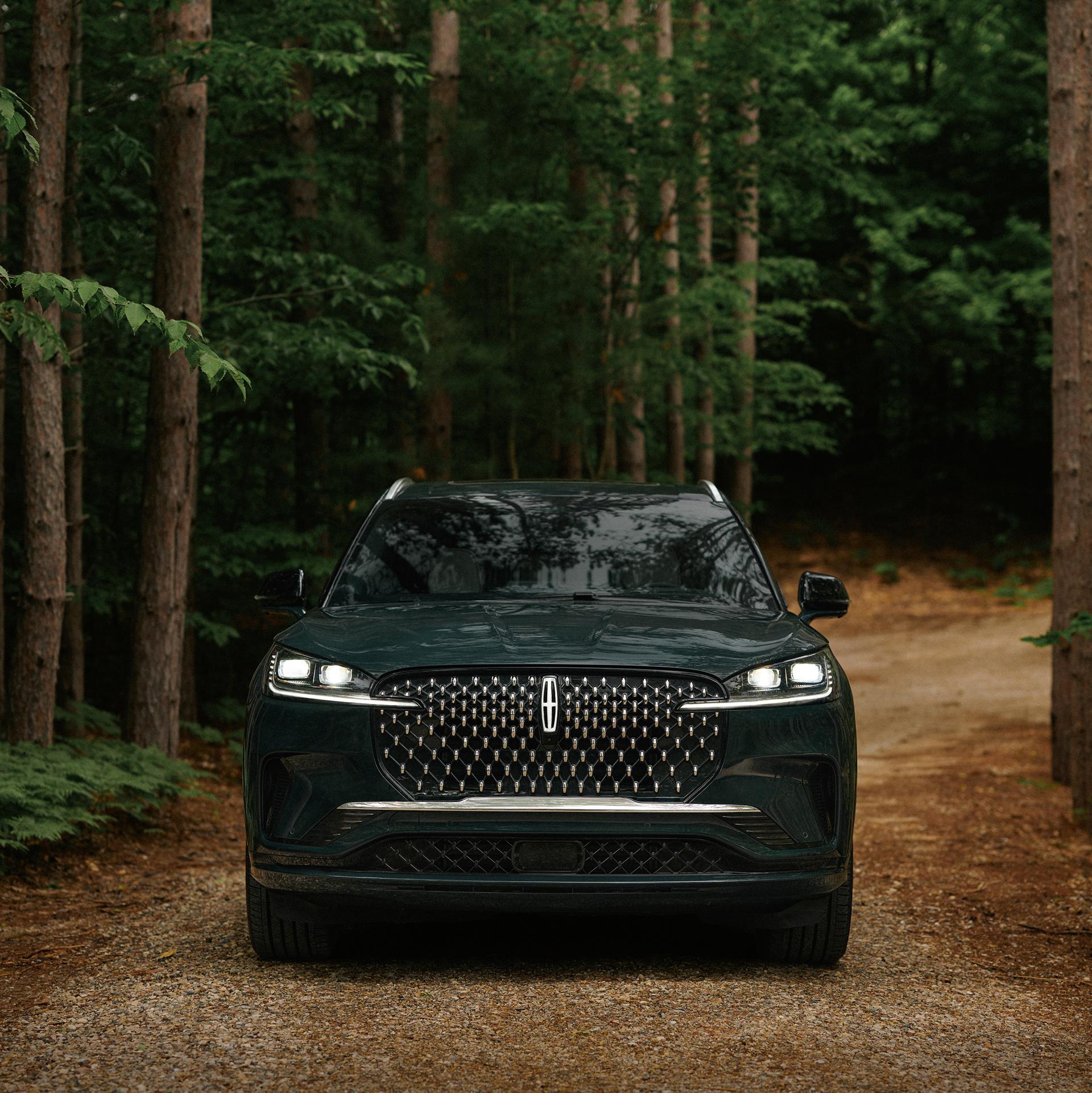 A 2027 Lincoln Aviator® SUV is being driven on a country road